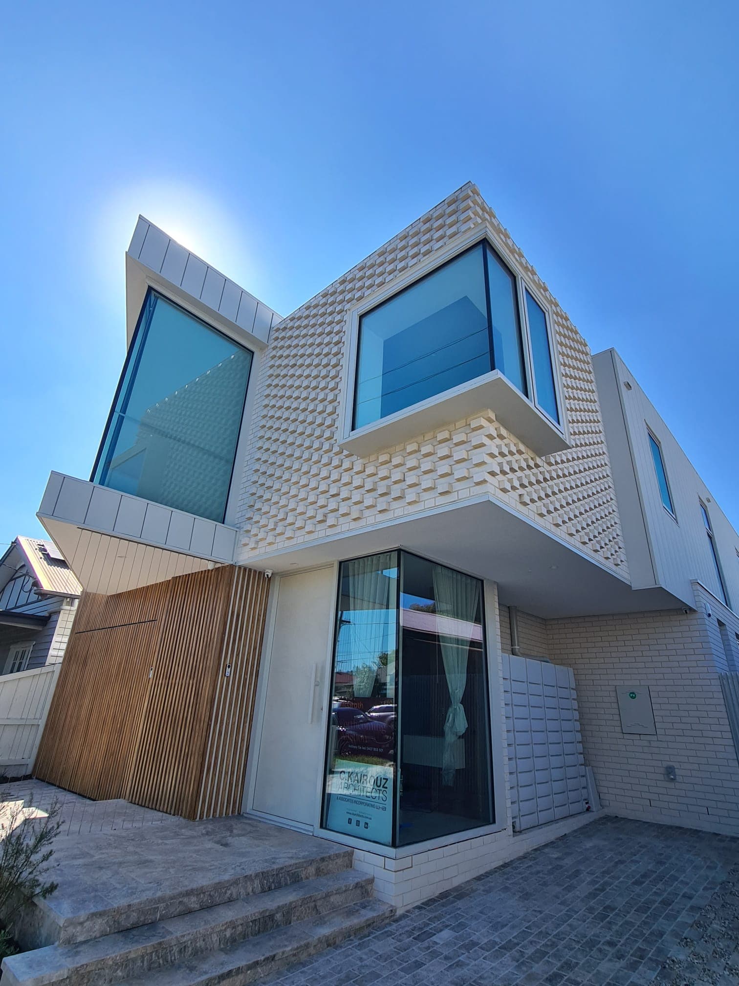 Bright contemporary two-storey home with white dental-pattern brickwork by Goodwin Bricklaying